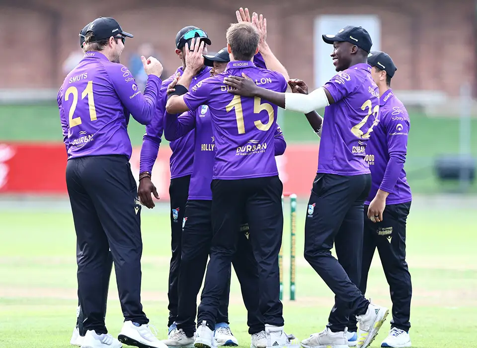 Dolphins cricket team huddle after getting a wicket