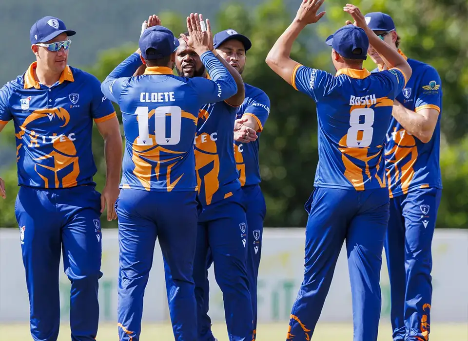Knights cricket team huddle after getting a wicket