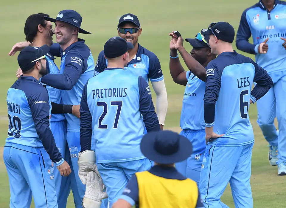 Titans cricket team huddle after getting a wicket